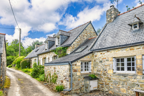 Road through a village in the French countryside with old idyllic stone houses