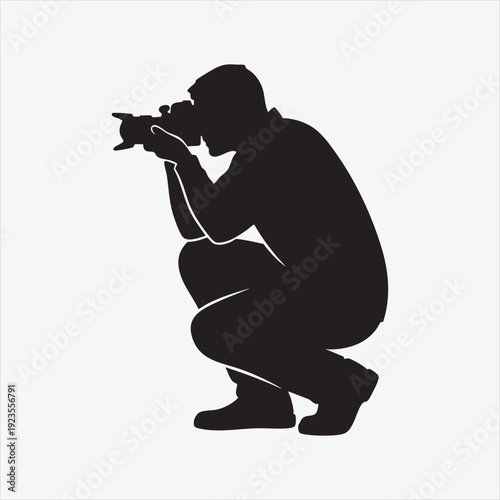 Silhouette of a Dedicated Photographer: A minimalist depiction captures the essence of a focused photographer at work, engrossed in capturing a moment through the lens.