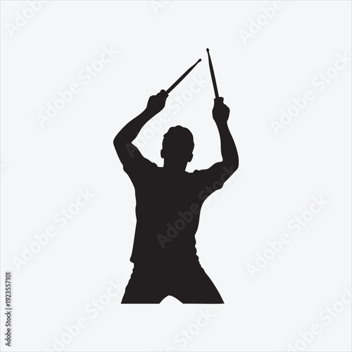 Silhouette of a Drummer in Action: A dynamic silhouette of a drummer, arms raised, poised to strike, captures the essence of rhythmic expression and musical passion.
