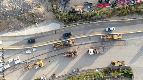 Foto Aerial view of road construction site with heavy machinery, trucks and workers p