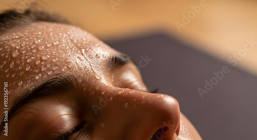 Close up shot of water droplets and perspiration on a person forehead during exercise