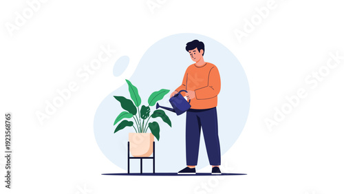 Young man in an orange sweater uses a blue watering can to take care of a large green indoor plant in a stylish pot on a minimalist stand.