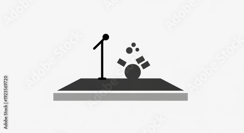 Stage with microphone and spotlight shining down on empty performance area with speaker
