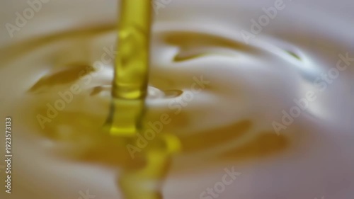 oil pouring into a cup