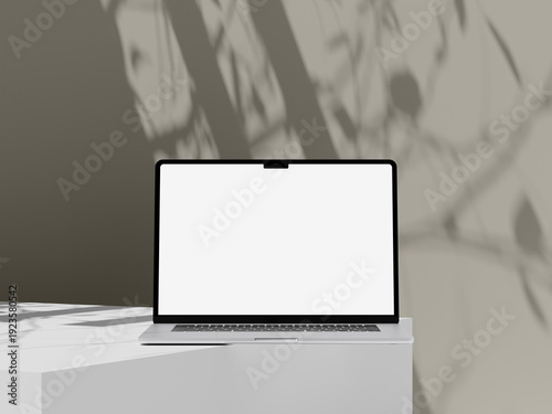 Front view laptop screen mockup on white pedestal with soft tan leaf shadows