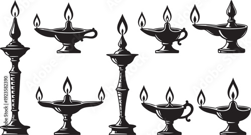 Collection of antique oil lamps with flames burning brightly