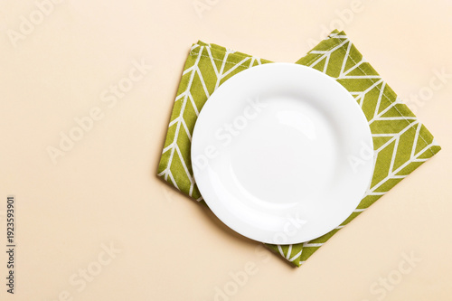 Wallpaper Mural Top view on colored background empty round white plate on tablecloth for food. Empty dish on napkin with space for your design Torontodigital.ca