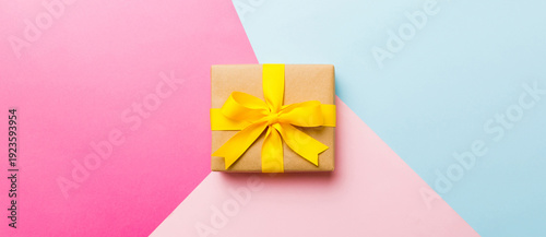 Wallpaper Mural holiday paper present tied yellow ribbon bow top view with copy space. Flat lay holiday background. Birthday or christmas present. Christmas gift box concept with copy space Torontodigital.ca