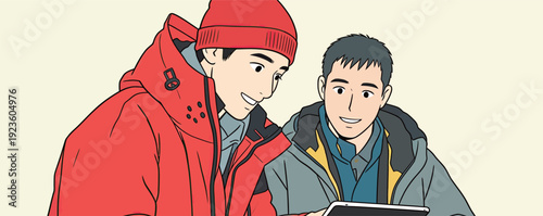 Two men look at a tablet together. They wear winter jackets and smile while engaging with the screen.