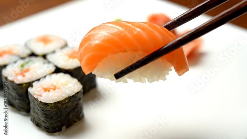 Delicious salmon sushi and maki rolls on a plate with wasabi