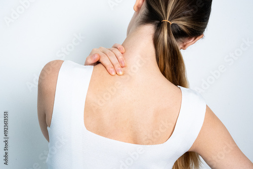 Woman Touching Neck from Behind Feeling Cervical Pain