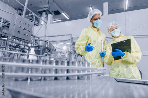 Food cannery industry hygiene worker check tin can for food product container, Canned food factory