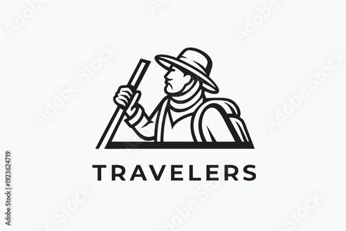 Silhouette of a man with backpack walks with stick towards snowy mountain