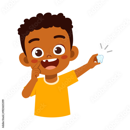 Happy African American boy proudly showing his missing front tooth and holding the fallen tooth