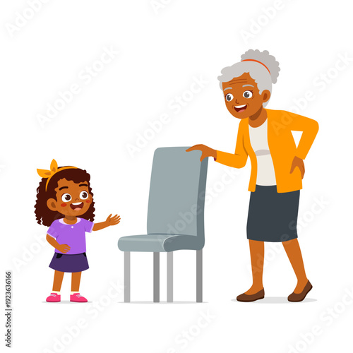 Smiling African American grandmother and cheerful granddaughter interacting happily by a chair