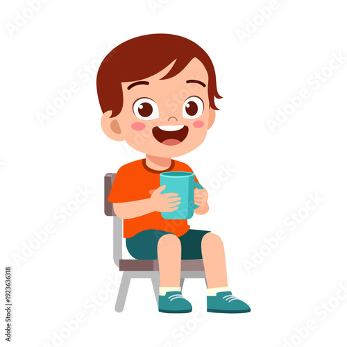 Happy smiling boy sitting on a chair holding blue cup with cheerful open mouth expression
