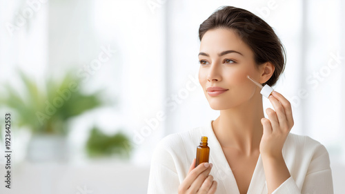Female model applying organic facial serum with dropper in bright minimalistic setting, showcasing skincare routine and natural beauty in a well-lit environment Free Download Female model applying organic facial serum with dropper in bright minimalistic setting, showcasing skincare routine and natural beauty in a well-lit environment - GFXLoad
