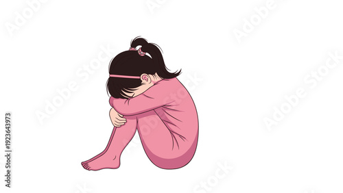 Sad young girl with dark hair in pigtails and pink pajamas sitting on the floor and crying with her head buried in her arms.