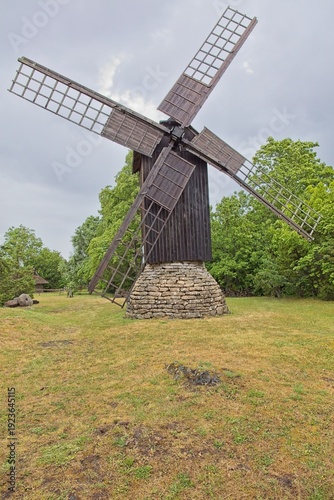 Eemu tuulik (Eemu windmill), traditional wooden post mill in cloudy summer weather, Muhu, Estonia, Europe.