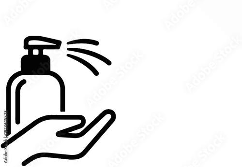 Hand holding a dispenser spraying liquid