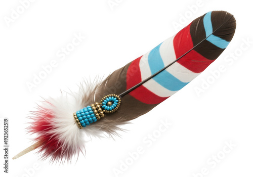 A colorful feather with beads and a white background