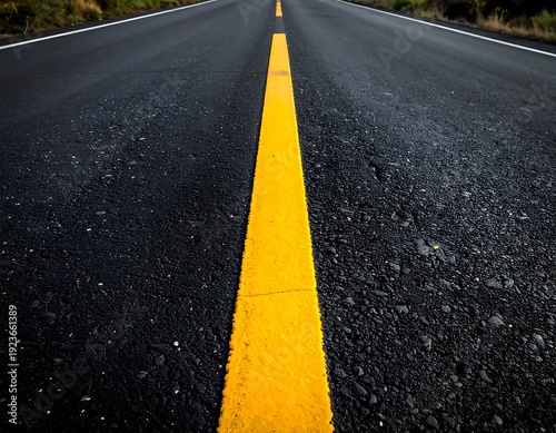 A long, straight road with a yellow line down the center