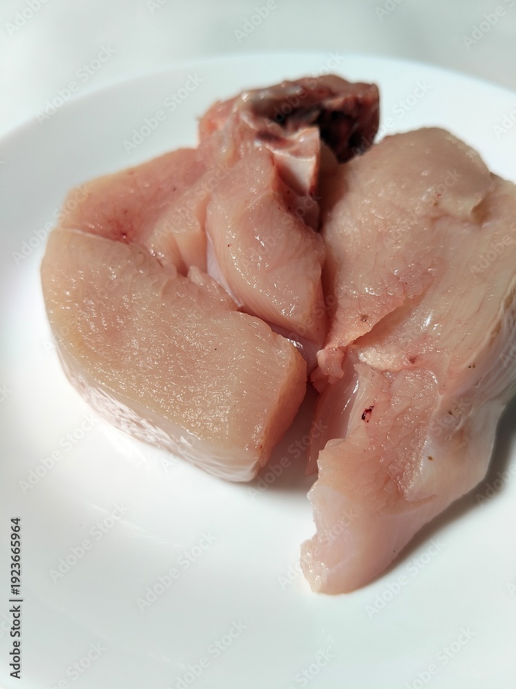Fototapeta premium Chicken pieces on a plate, a basic ingredient in a food menu.