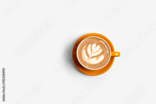 Fotografía Top view latte art coffee in orange cup isolated on white background