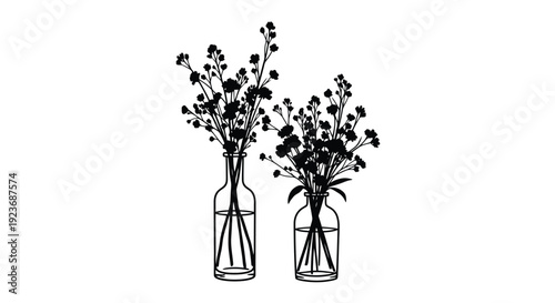 Two vases filled with delicate flower arrangements in black and white