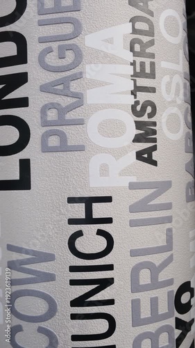 a modern wallpaper design characterized by an urban typography pattern of world city names