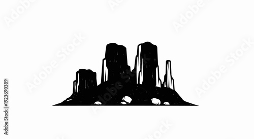 Silhouette of towering mesa rock formations in a desert landscape