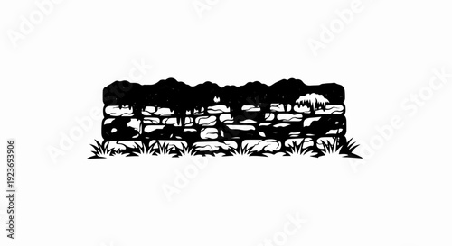 Silhouette of a stone wall with vegetation overgrowth and grass
