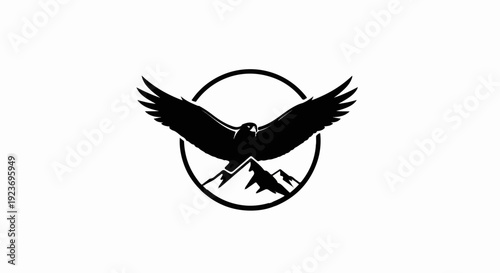 Silhouette of eagle with spread wings over mountains within circle