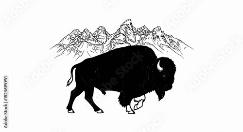 Silhouette of a bison in front of jagged mountain peaks