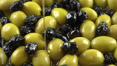 pouring olive oil on olives
