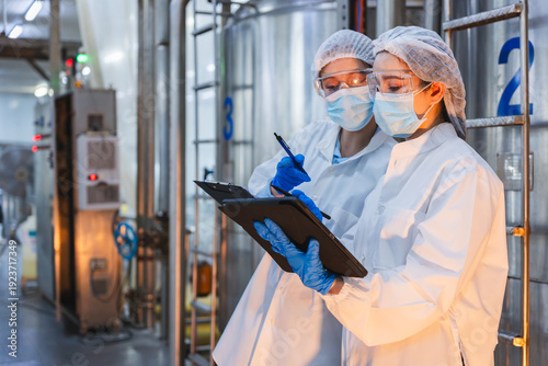 Bild auf Leinwand Female scientists wearing face masks and safety goggles working in high-standard