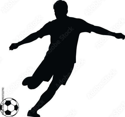 Soccer player silhouette powerfully kicks a classic black and white.