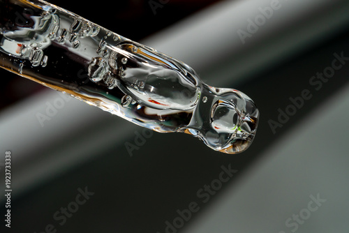 An eyedropper with a drop of oil or a cosmetic product for face and body. Natural organic cosmetics. The concept of body care.