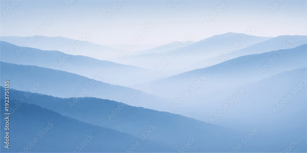 Obraz premium A misty morning sunrise illuminates a blue mountain range where fog and clouds drift over the forest valley and hills in a serene winter nature landscape
