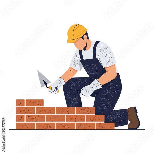 Construction worker building brick wall with trowel and mortar