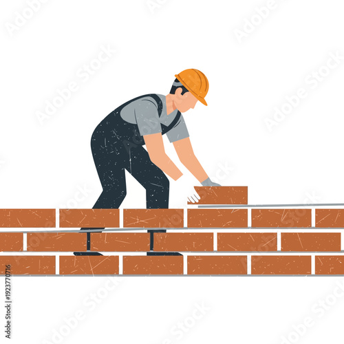 Construction worker building brick wall, wearing hard hat and overalls