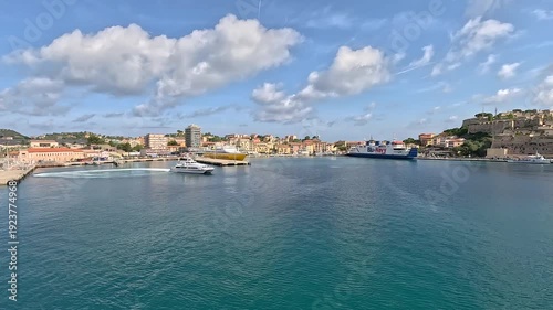 Wallpaper Mural Timelaps. A quick shot of a ship sailing against the backdrop of a shore and a city. Torontodigital.ca