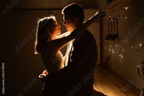Silhouette of loving couple embracing and hugging each other in the kitchen. Happy young couple in love. Love, romantic, tenderness and Valentines day