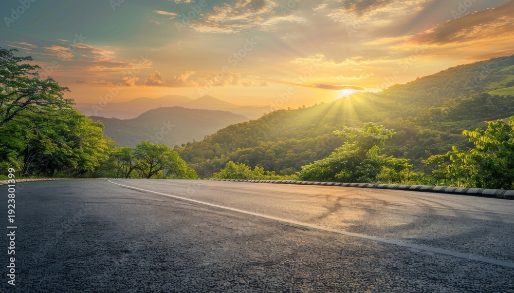 Naklejka premium Scenic landscape view of a winding road through lush green mountains at sunset against a colorful sky