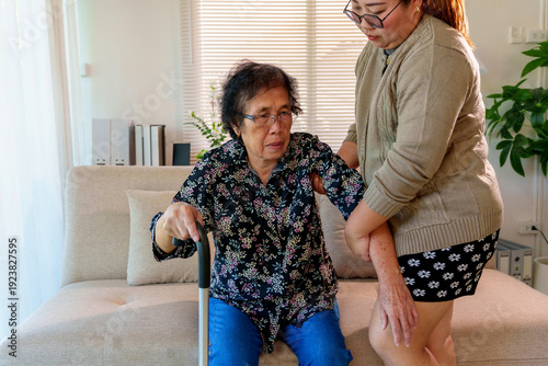 Tableau sur toile Young woman home caregiver providing empathy and support helping an elderly woma