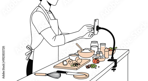 A person in an apron filming food preparation with a smartphone on a stand in a kitchen with various ingredients and utensils.