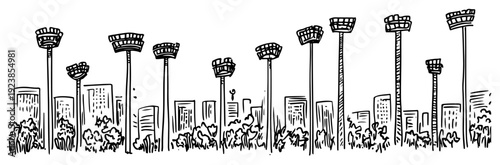 Row of stadium floodlights standing in front of a city skyline with buildings and park