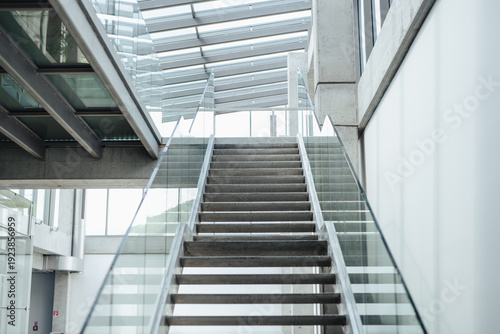 Obraz na plátně Minimalist concrete stairs with glass railing in modern interior.