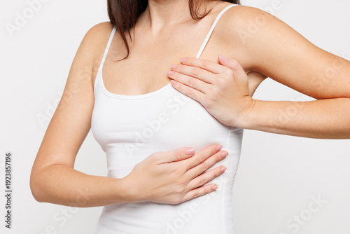 Wallpaper Mural Cropped close up young woman with slim body wear tank top put hands on breast checks for any growths or tumors isolated on plain solid white background studio portrait Breast Cancer Awareness concept Torontodigital.ca