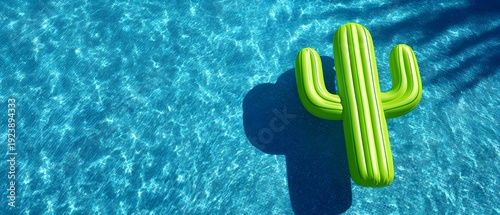 Green inflatable cactus floating on clear blue pool water with sunlight reflections